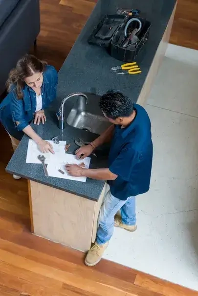 Personas hablando sobre unos planos de trabajo